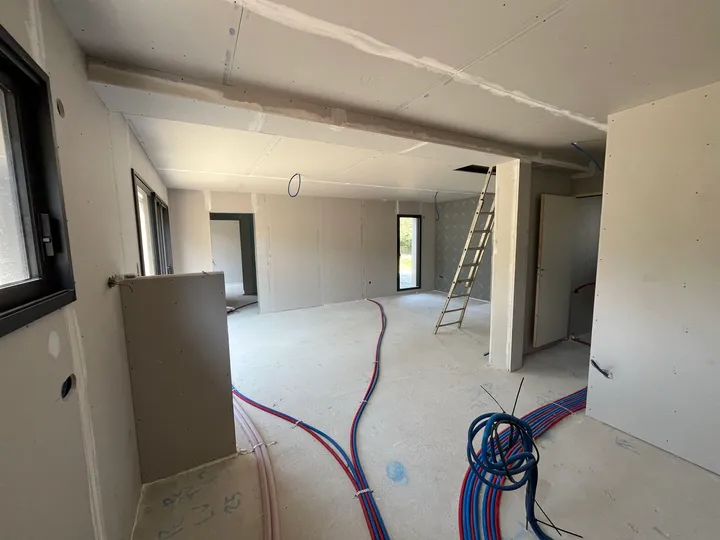 Cloisons et plafonds en plaque de plâtre dans un espace ouvert, réseaux et joints encore visibles